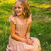 Ellianna is registered to the contest to win money with this photo: child, girl, smiling, outdoor, grass, dress, sunlight, nature, greenery, happy, sitting, wavy_hair, pretty, young, portrait, daylight, casual, cute, childhood, summer