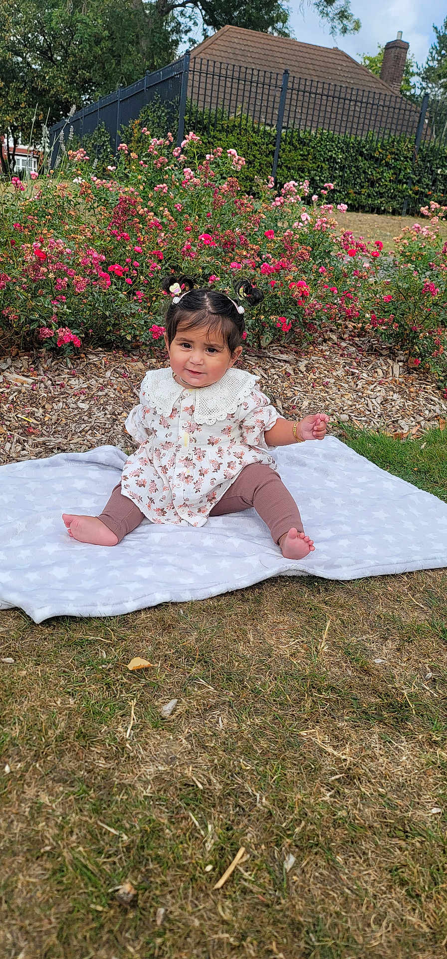 Sidak joined the competition — help win amazing prizes! baby, child, girl, outdoor, grass, flowers, blanket, pigtails, smile, garden, nature, plants, house, fence, greenery, cute, sitting, clothing, portrait, daylight