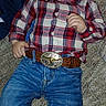 Andrew joined the competition — help win amazing prizes! child, baby, plaid_shirt, jeans, belt, carpet, toy, pink_toy, blue_clothing, face, hand, casual_wear, indoor, laying_down, curious_expression, young_child, infant, clothing, portrait, floor