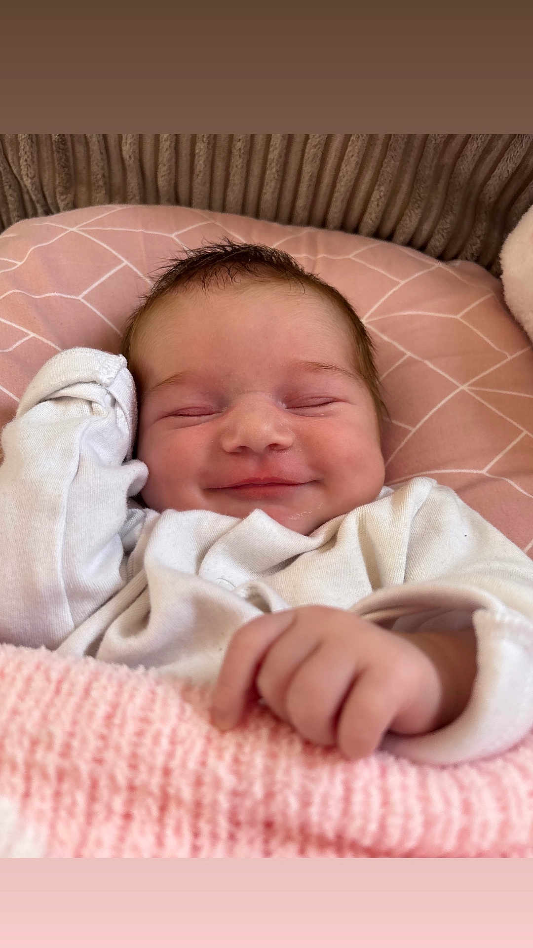 Arabella Rose joined the competition — help win amazing prizes! baby, smiling, infant, blanket, cushion, white_clothing, face, hand, resting, cozy, pink, soft_texture, sleepy, cute, newborn, portrait, indoors, comfort, child, peaceful
