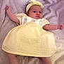 baby, infant, yellow_dress, headband, blanket, white_socks, lying_down, soft_texture, cute, child, newborn, portrait, indoors, clothing, baby_girl, adorable, resting, headwear, small_arms, soft_lighting