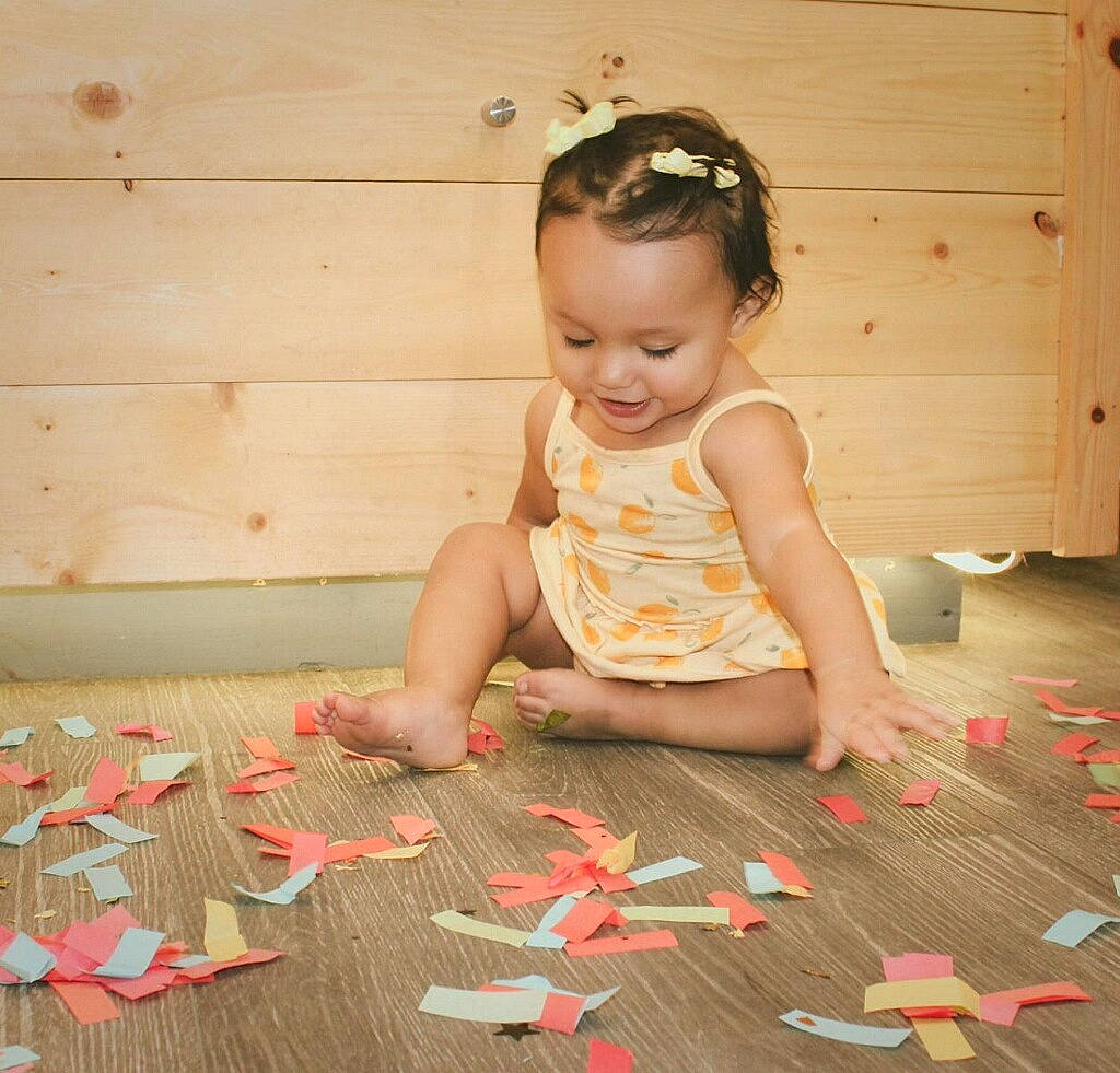 Melanie joined the competition — help win amazing prizes! baby_toddler_clothing, beauty, child, flooring, foot, fun, happy, hardwood, nail, paper, paper_product, pattern, person, petal, pink, plant, room, sitting, smile, toddler