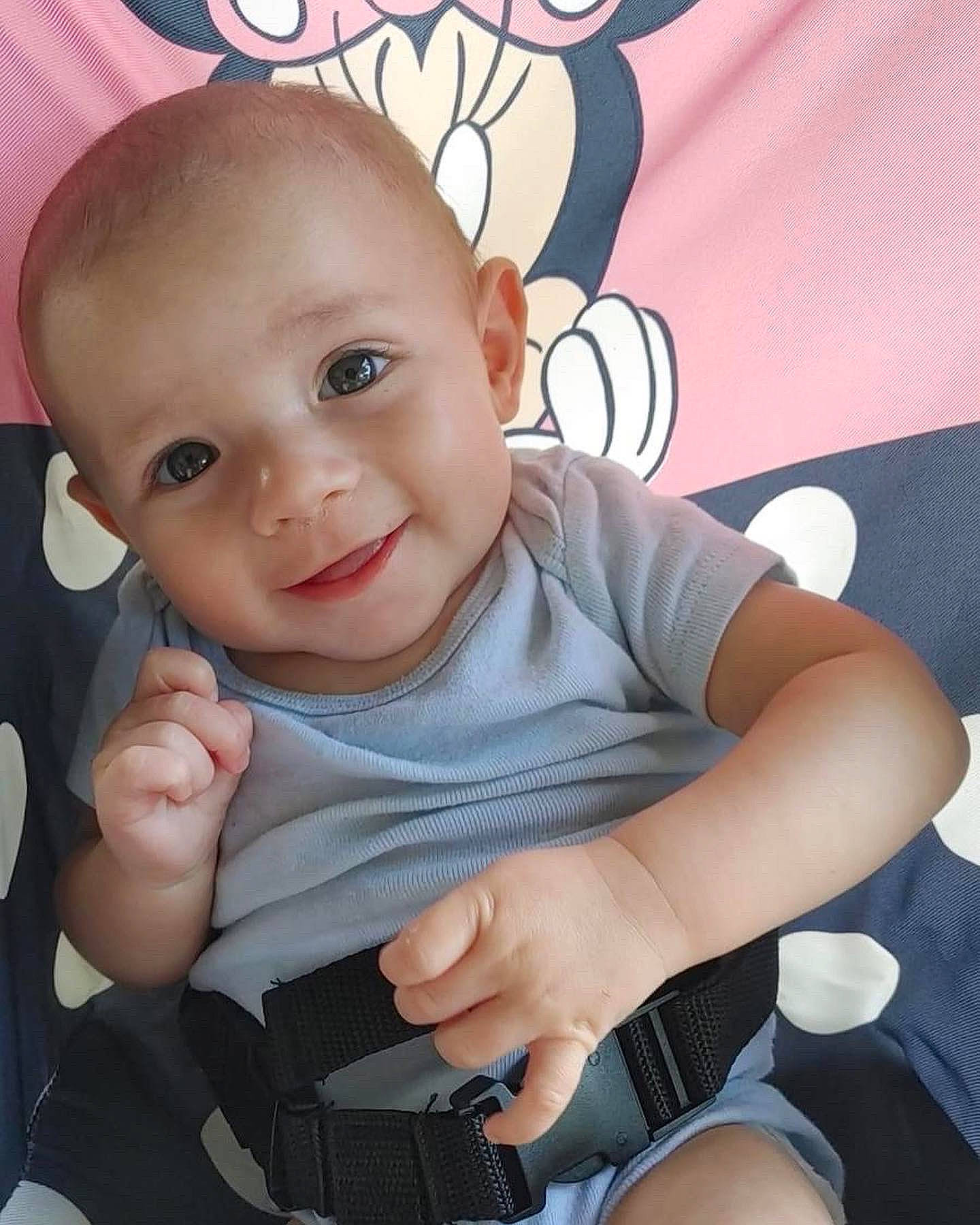 Layton is registered to the contest to win money with this photo: arm, baby_toddler_clothing, cheek, comfort, eye, finger, gesture, hairstyle, hand, happy, human_body, iris, joy, mouth, nose, person, pink, skin, sleeve, smile