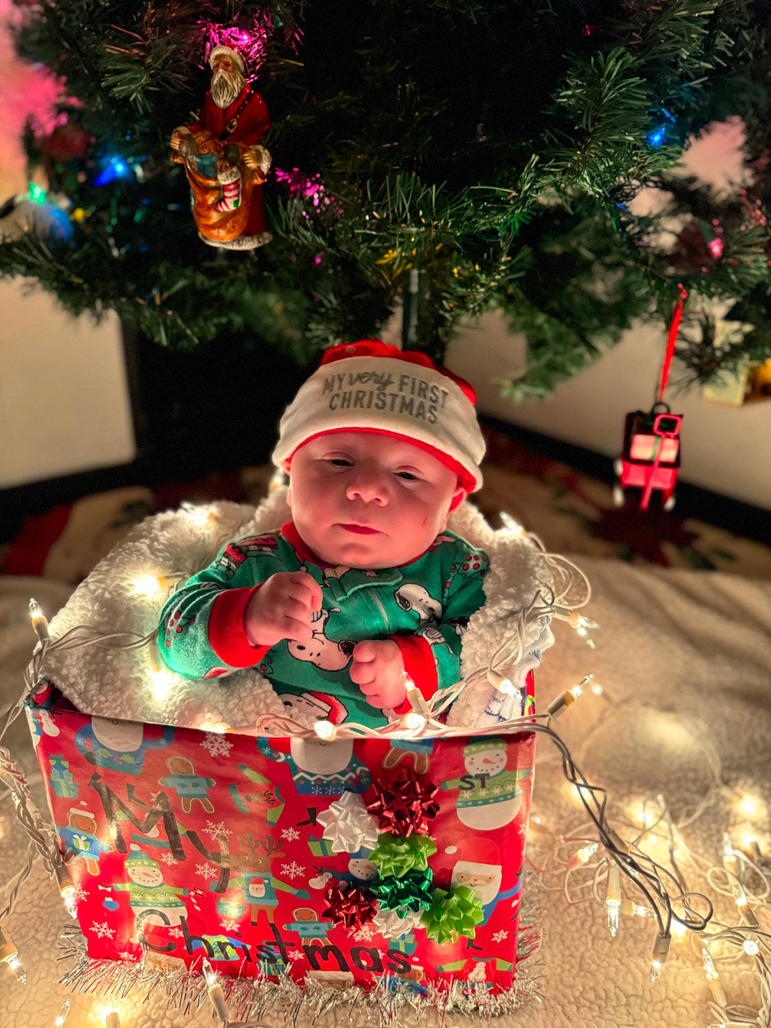 Timothy is registered to the contest to win money with this photo: christmas, christmas_decoration, christmas_eve, christmas_ornament, christmas_tree, conifer, event, evergreen, happy, headwear, holiday, holiday_ornament, interior_design, light, ornament, person, plant, toddler, tradition, tree