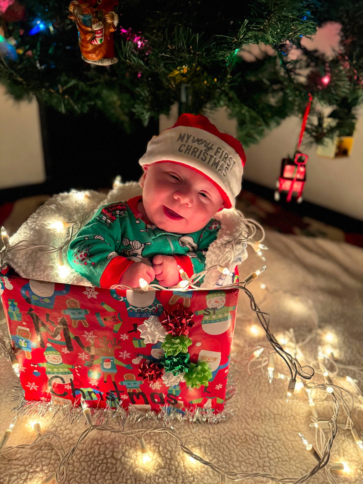 Timothy joined the competition — help win amazing prizes! baby, baby_toddler_clothing, christmas, christmas_decoration, christmas_eve, christmas_ornament, christmas_tree, event, fun, happy, head, headwear, holiday, holiday_ornament, human_body, light, person, plant, toddler, tradition