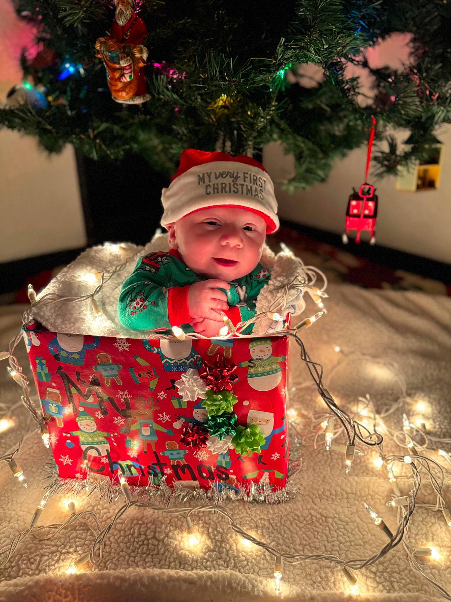 Timothy joined the competition — help win amazing prizes! christmas, christmas_decoration, christmas_eve, christmas_ornament, christmas_tree, conifer, event, fictional_character, happy, headwear, holiday, holiday_ornament, human_body, interior_design, light, ornament, person, shortstraw_pine, toddler, tradition