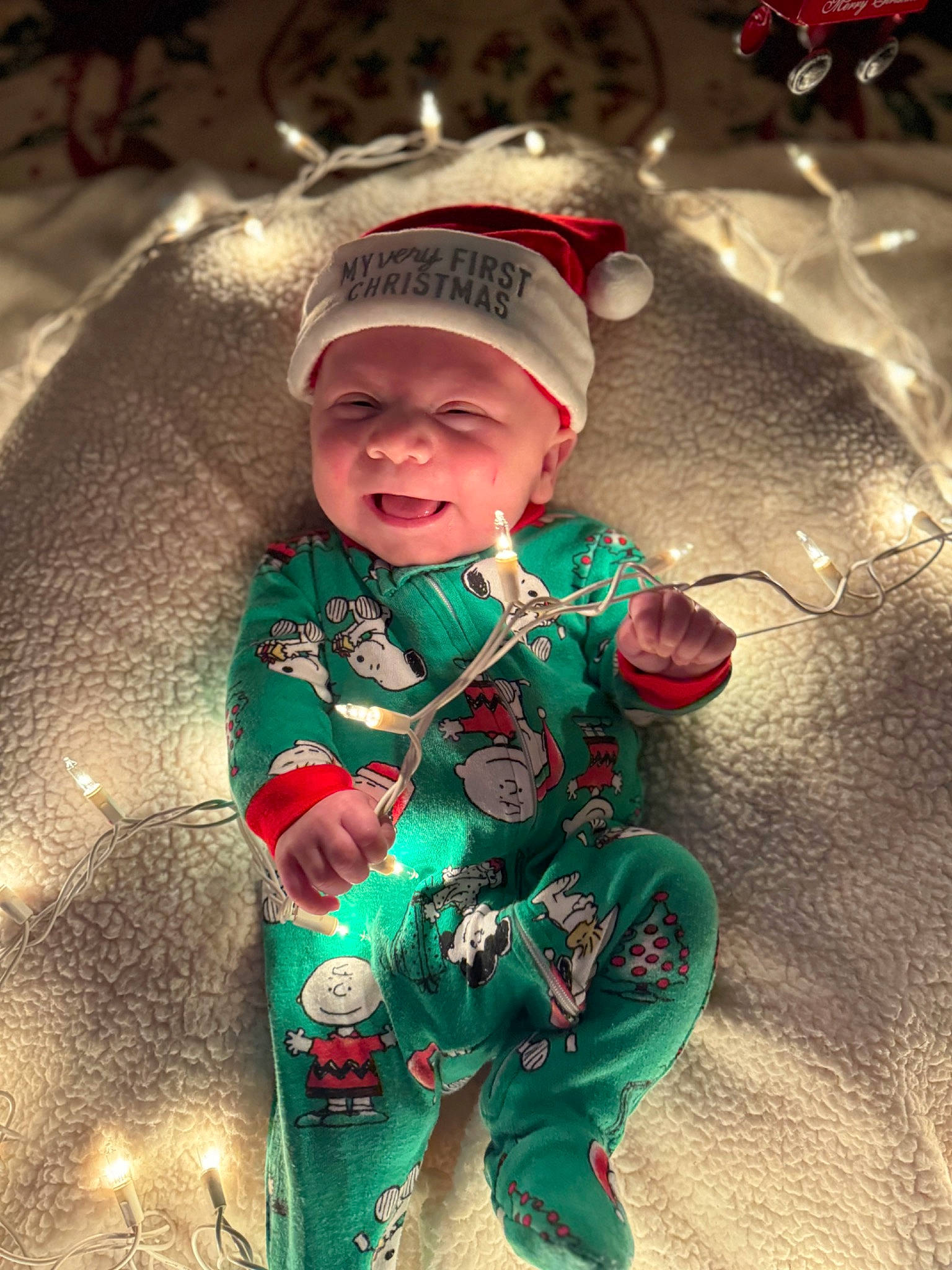 Timothy is registered to the contest to win money with this photo: baby, baby_toddler_clothing, child, christmas, christmas_decoration, christmas_eve, christmas_ornament, costume_hat, event, fun, grass, happy, headwear, holiday, human_body, people_in_nature, person, plant, smile, toddler