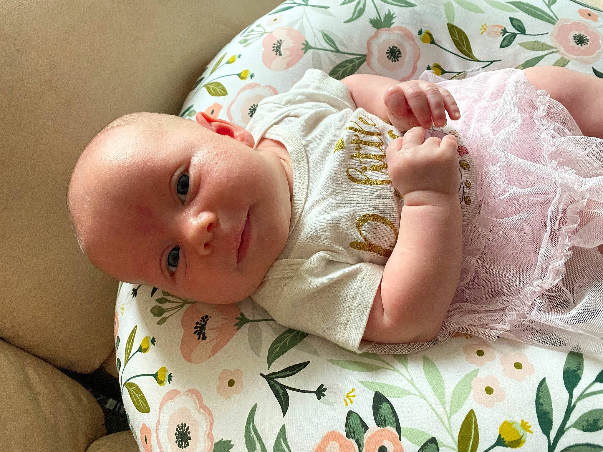 Octavia is registered to the contest to win money with this photo: arm, baby, baby_toddler_clothing, cheek, clothing, comfort, dress, eye, finger, green, hand, head, headgear, iris, person, product, skin, sleeve, textile, toddler