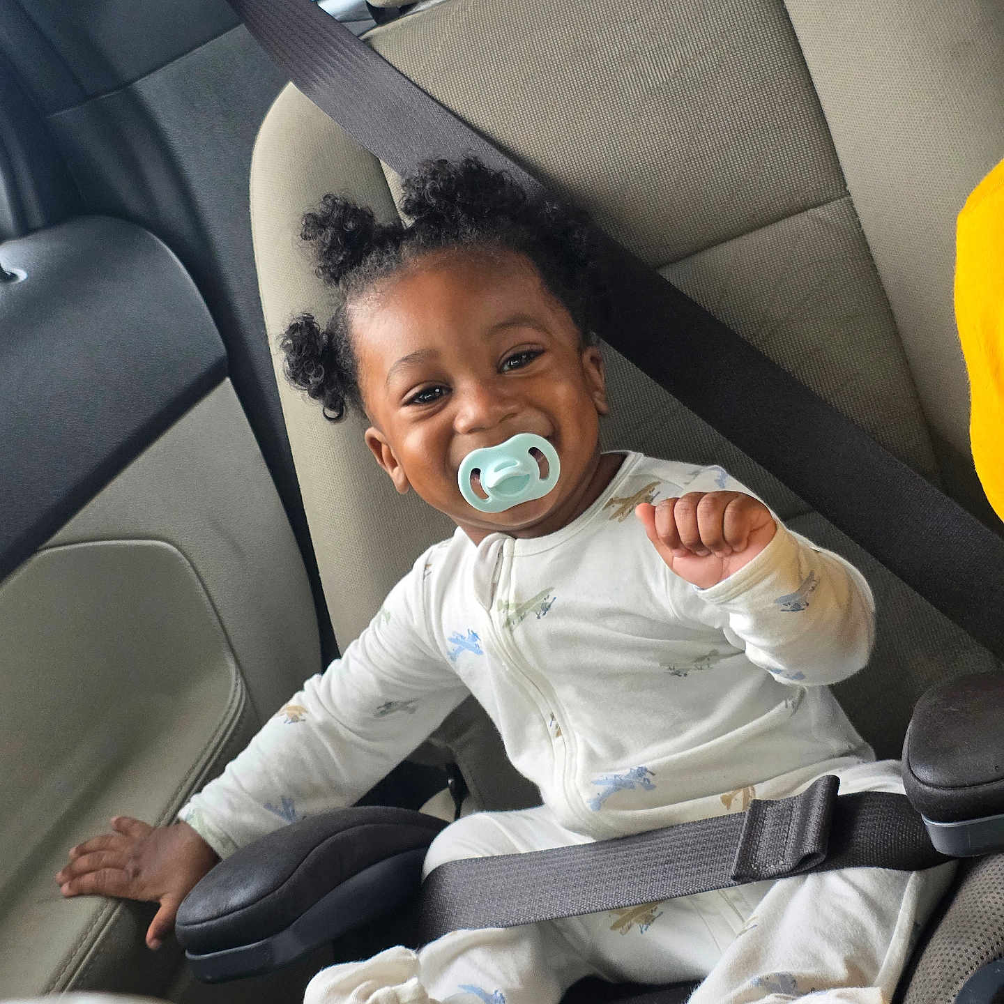 Josiah joined the competition — help win amazing prizes! toddler, child, smiling, pacifier, car_seat, seatbelt, curly_hair, white_pajamas, happy, baby, infant, automobile, interior, safety, cute, portrait, hand, seat, clothing, person