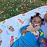 Josiah joined the competition — help win amazing prizes! baby, child, pacifier, blanket, outdoor, grass, leaves, toy, blue_clothing, cartoon_character, cute, lying_down, hair_buns, infant, nature, fall, smiling, person, toddler, playtime