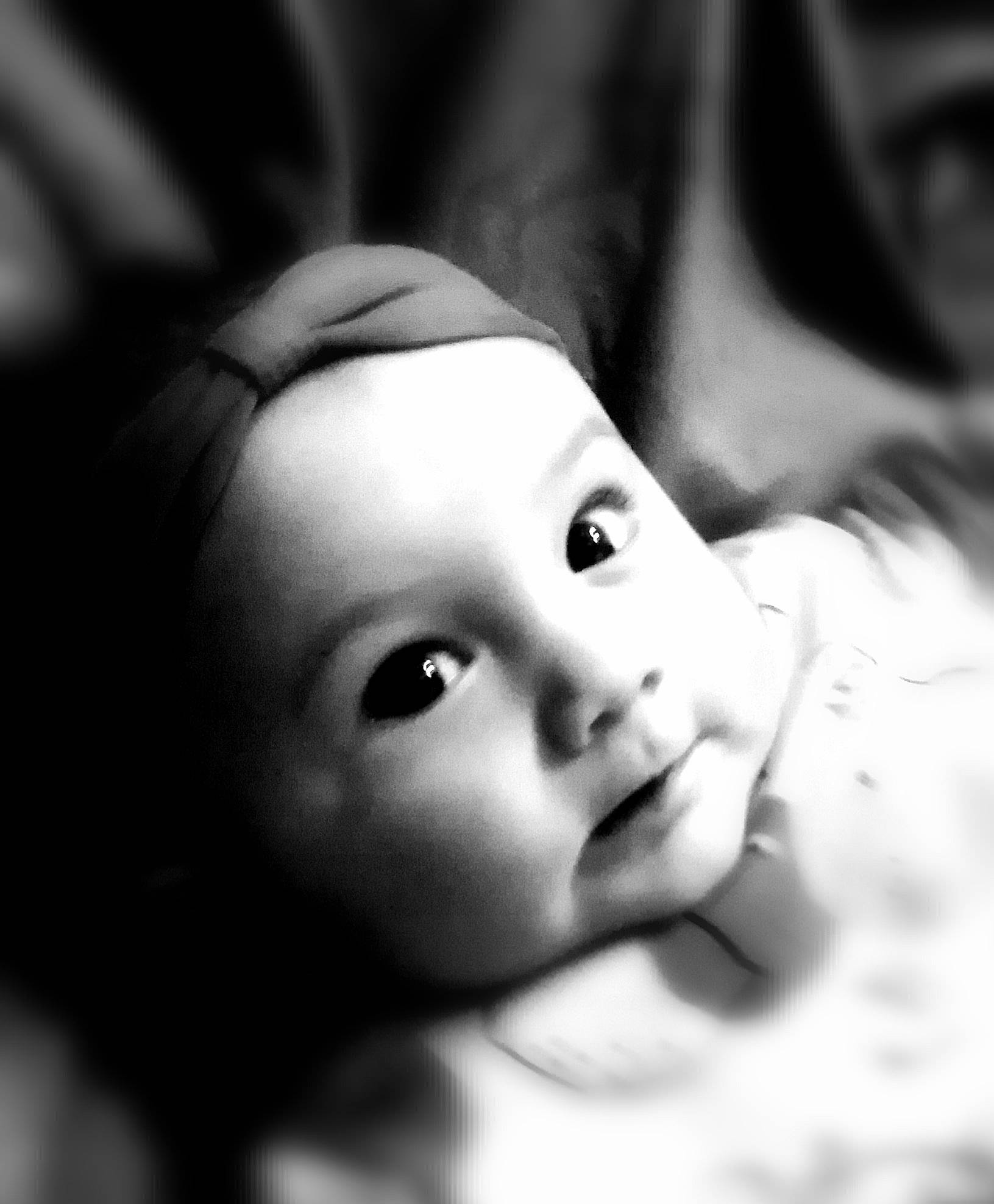 Ninon participe au concours pour gagner de l'argent avec cette photo : baby, cheek, child, close_up, comfort, darkness, ear, eyelash, flash_photography, gesture, happy, iris, lip, monochrome, monochrome_photography, no_expression, nose, person, portrait_photography, smile