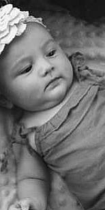 Ninon participe au concours pour gagner de l'argent avec cette photo : baby, black, black_and_white, cheek, eye, eyelash, face, flash_photography, forehead, gesture, hand, happy, headwear, human_body, iris, lip, mouth, nose, person, skin