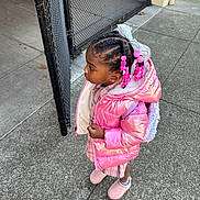 Malani joined the competition — help win amazing prizes! child, girl, pink_jacket, beads, hair_braids, sidewalk, chain_link_fence, outdoor, curious, winter_clothing, boots, backpack, urban, concrete, street, portrait, standing, fashion, accessories, daylight