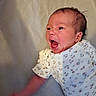 Rosalie is registered to the contest to win money with this photo: arm, baby, child, closeup, cute, expression, face, floral_pattern, head, indoor, infant, lying_down, mouth_open, newborn, onesie, person, skin, small, soft_light, yawn
