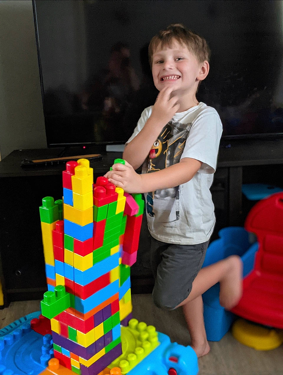 Kenneth is registered to the contest to win money with this photo: adhesive, baby_playing_with_toys, child, educational_toy, event, fun, interlocking_block, joy, leisure, mechanical_puzzle, party, person, plastic, play, puzzle, recreation, shorts, smile, t_shirt, toddler
