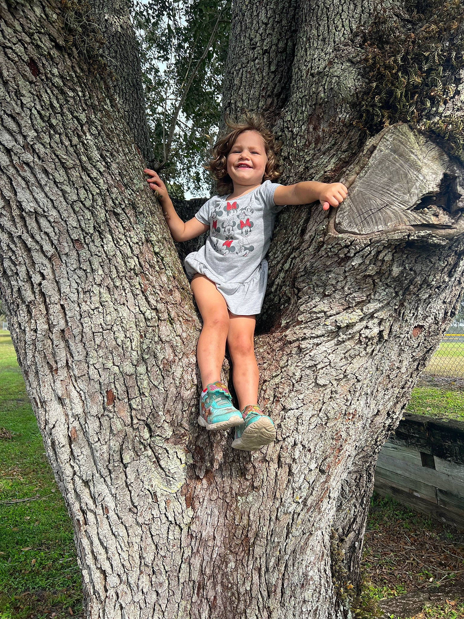 Selina is registered to the contest to win money with this photo: branch, eye, forest, fun, grass, happy, head, joy, leg, leisure, people_in_nature, person, plant, recreation, shorts, standing, t_shirt, thigh, tree, trunk