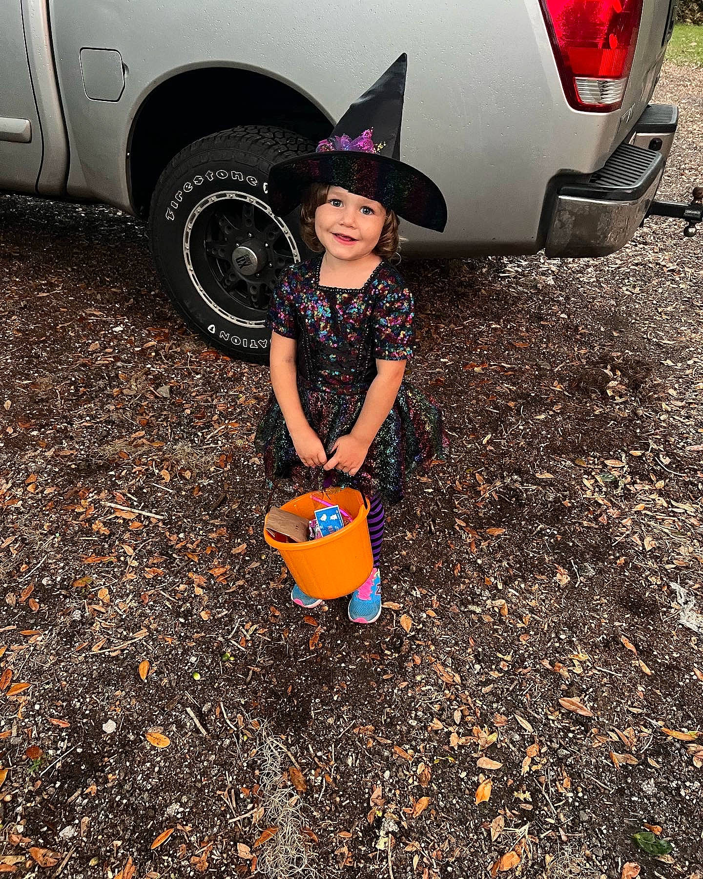 Selina joined the competition — help win amazing prizes! asphalt, automotive_design, automotive_exterior, automotive_lighting, automotive_tire, car, fender, happy, hat, headwear, joy, leg, light, motor_vehicle, people_in_nature, person, plant, road_surface, tints_and_shades, tire