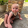 Titan is registered to the contest to win money with this photo: baby, child, crawling, brick_pillar, concrete, outdoor, flower_pot, pink_flowers, greenery, sunlight, curious, rosy_cheeks, short_hair, tank_top, barefoot, sidewalk, nature, garden, portrait, person