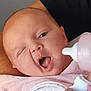 baby, infant, bottle, feeding, pink_bib, hand, arm, skin, face, mouth, tongue, winking, person, closeup, cute, expression, holding, clothing, nurturing, care