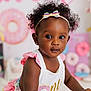 Willow is registered to the contest to win money with this photo: toddler, child, headband, curly_hair, pink, white_clothing, donut, birthday, party, colorful, cute, smiling, indoor, decorations, celebration, young_child, portrait, playful, happy, person