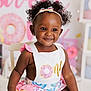 Willow joined the competition — help win amazing prizes! toddler, child, smiling, sitting, headband, curly_hair, birthday, donut, colorful_clothing, chair, indoor, celebration, happy, cute, portrait, one_year_old, party, pastel_colors, decorations, face