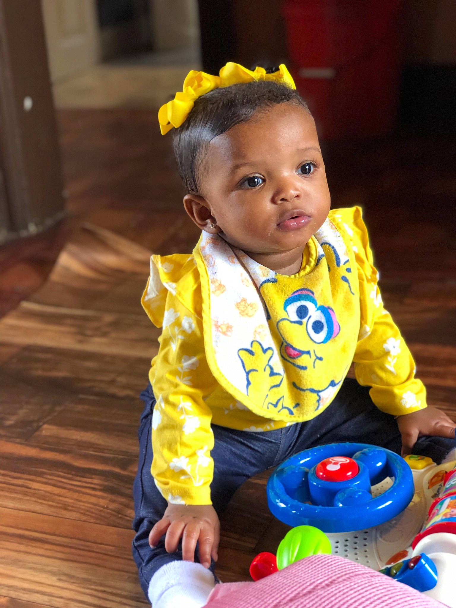 Melani is registered to the contest to win money with this photo: baby, baby_playing_with_toys, baby_products, baby_toddler_clothing, baby_toys, child, fun, party_supply, person, play, product, sitting, skin, smile, toddler, toy, yellow