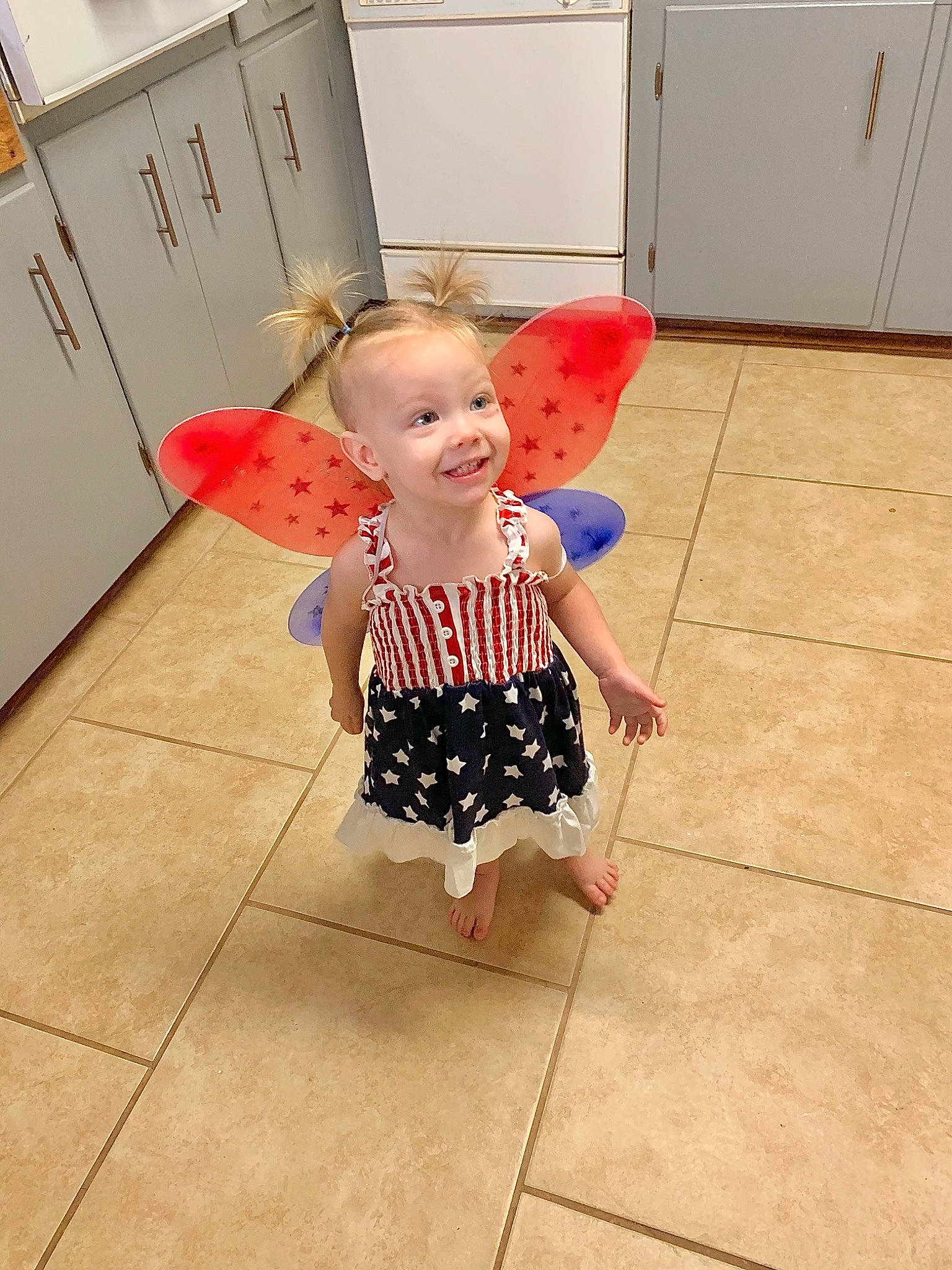 Everleigh joined the competition — help win amazing prizes! baby_toddler_clothing, barefoot, cabinetry, cupboard, floor, flooring, fun, happy, head, human_leg, joint, joy, kitchen_appliance, pattern, person, refrigerator, sleeve, smile, t_shirt, toddler