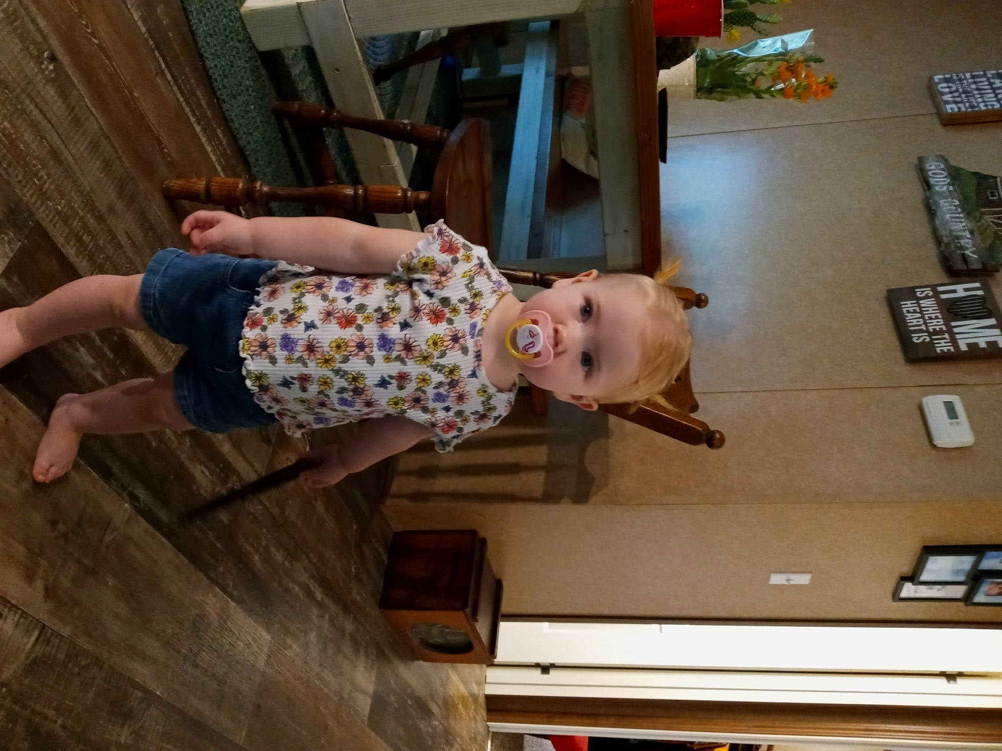 Kyndall is registered to the contest to win money with this photo: baby, baby_toddler_clothing, child, floor, flooring, fun, hardwood, house, houseplant, human_leg, pattern, person, room, smile, standing, t_shirt, thigh, toddler, varnish, wood