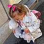 Alexia a rejoint le concours — aidez-le/la à gagner de superbes lots ! backpack, boots, building, child, cute, door, girl, holding, innocent, jacket, outdoor, person, pink_bows, playful, portrait, sidewalk, stuffed_animal, toddler, toy, warm_clothing