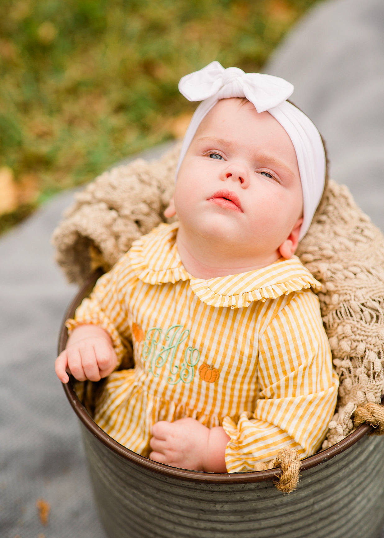 Raelynn is registered to the contest to win money with this photo: baby, baby_products, baby_toddler_clothing, basket, cap, cheek, child, fashion_accessory, grass, happy, headwear, jewellery, leaf, outerwear, pattern, peach, people_in_nature, person, sitting, skin