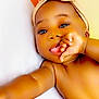 Jaielle joined the competition — help win amazing prizes! baby, infant, child, headband, bow, skin, hand, thumb, face, eyes, lying_down, arm, leg, cute, portrait, closeup, indoors, soft_light, warm_colors, skin_tone