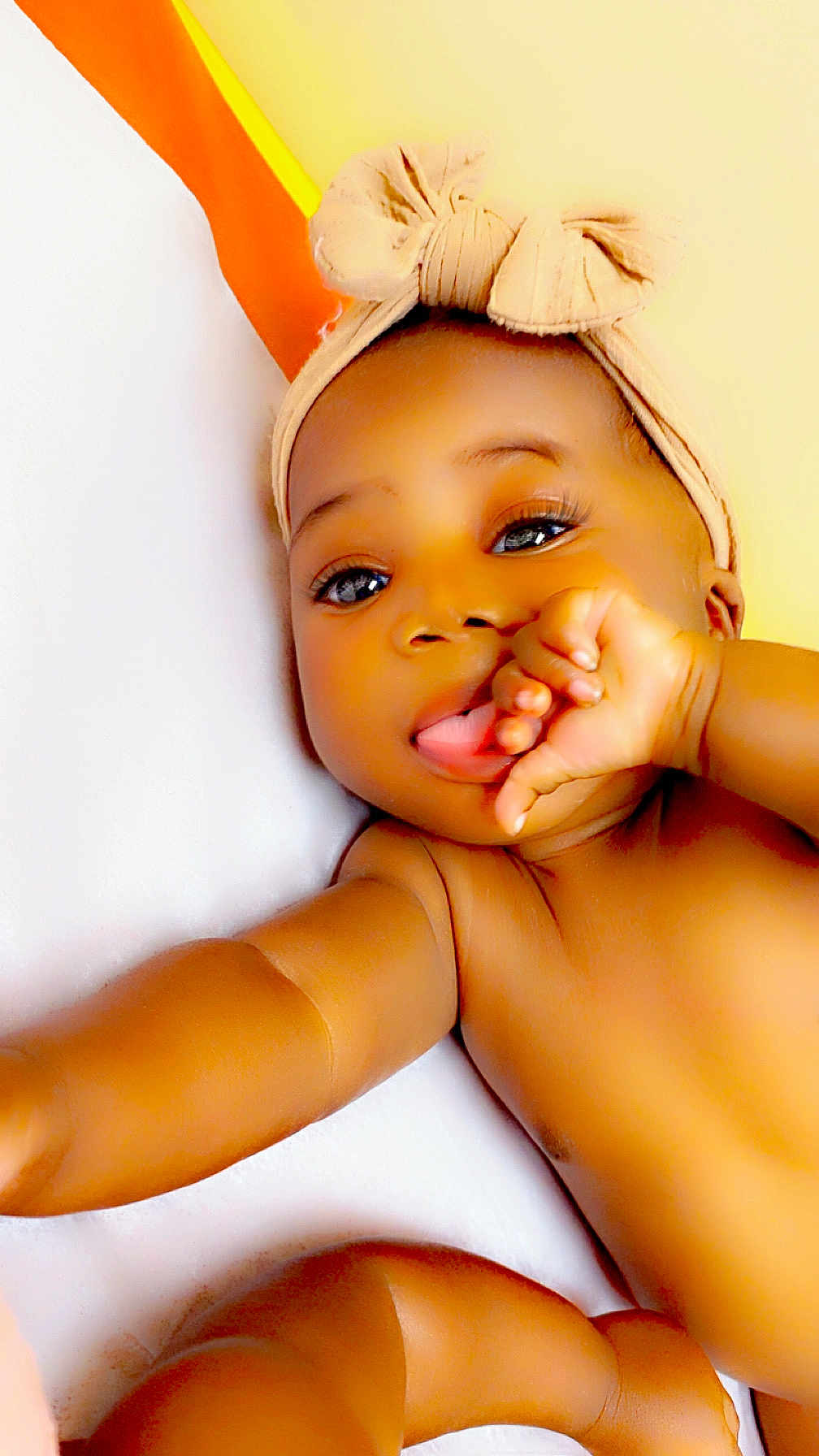 Jaielle joined the competition — help win amazing prizes! baby, infant, child, headband, bow, skin, hand, thumb, face, eyes, lying_down, arm, leg, cute, portrait, closeup, indoors, soft_light, warm_colors, skin_tone
