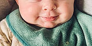 Lily is registered to the contest to win money with this photo: baby, infant, smiling, face, pacifier, blanket, bib, clothing, head, cheeks, cute, happy, portrait, closeup, indoors, child, newborn, soft_texture, cozy, warm