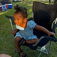 Nykeriah joined the competition — help win amazing prizes! black_chair, casual, chair, child, cooler, daylight, dress, gathering, grass, outdoor, park, people, pigtails, playground, shoes, summer, sunlight, toddler, trees, vehicle