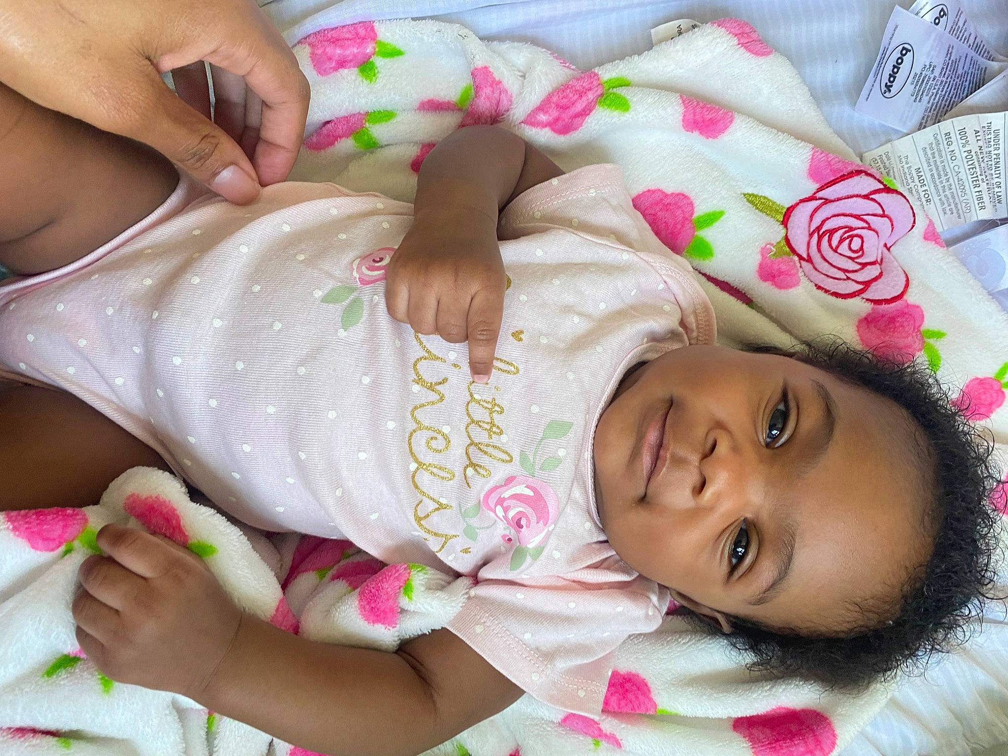 Iylani joined the competition — help win amazing prizes! baby, baby_toddler_clothing, beauty, cheek, child, comfort, eyelash, finger, happy, human_leg, linens, magenta, nail, pattern, person, pink, skin, smile, textile, thigh