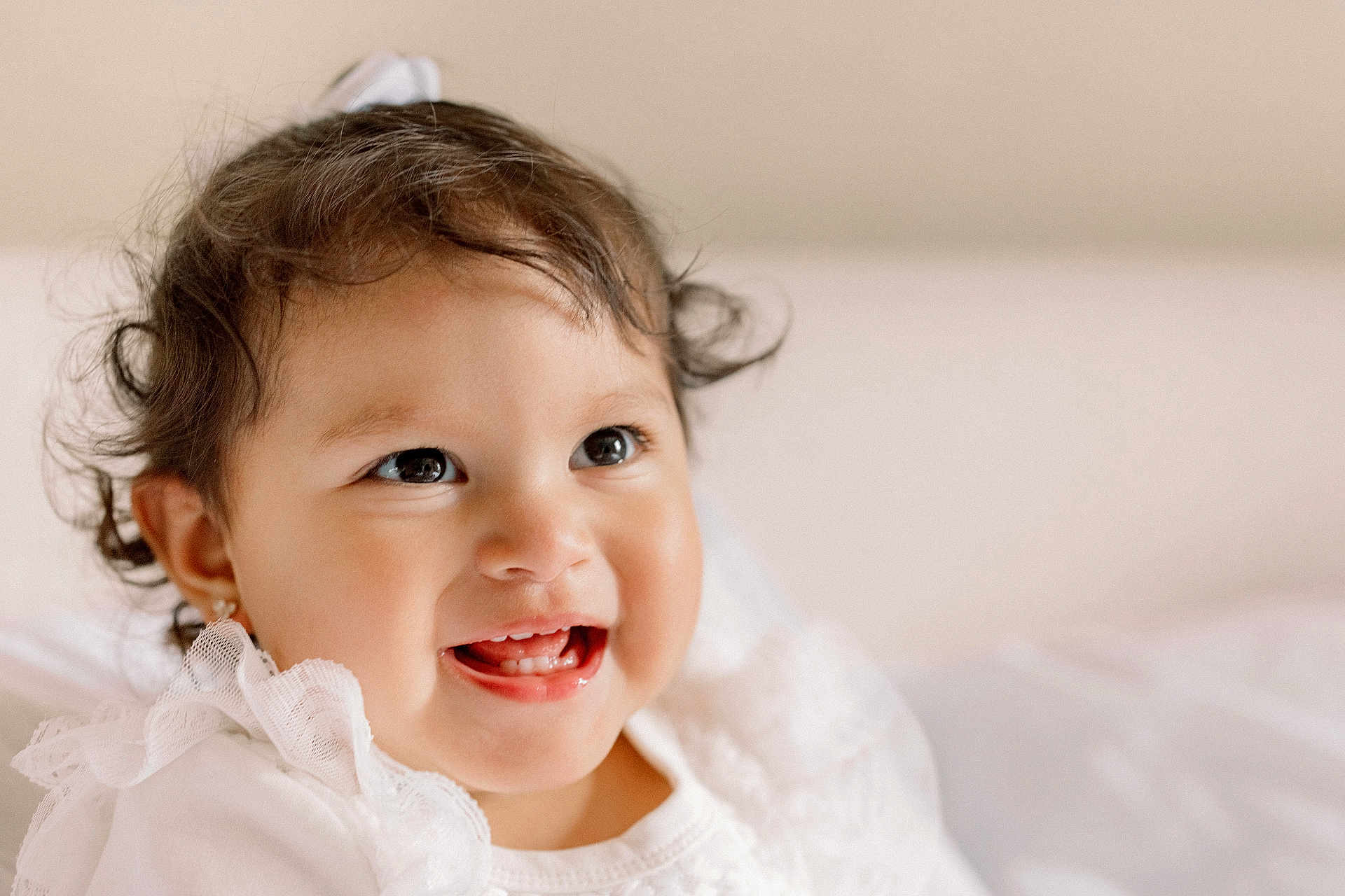 Valentina joined the competition — help win amazing prizes! baby, child, smiling, teeth, lace, white_clothing, earrings, curly_hair, portrait, closeup, happy, cute, infant, face, skin, young, indoors, soft_light, expression, joy