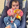 baby, infant, stroller, car_seat, plush_toy, harness, buckle, pink_sweater, denim_jeans, heart_pattern, socks, sitting, looking_at_camera, big_eyes, chubby_cheeks, indoor, tiled_floor, pacifier_clip, cute, portrait