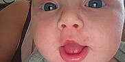 Aryah is registered to the contest to win money with this photo: baby, face, blue_eyes, drool, close_up, infant, skin, mouth_open, clothing, person, head, shoulder, blurred_background, indoor, expression, curious, scratched_forehead, ribbed_fabric, light_green, human