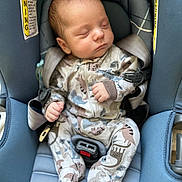 Sylas is registered to the contest to win money with this photo: baby, sleeping, car_seat, infant, pajamas, dinosaur_pattern, child, seatbelt, cute, peaceful, newborn, clothing, safety, rest, indoors, portrait, small_hands, head, closed_eyes, soft_lighting