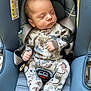baby, sleeping, car_seat, infant, pajamas, dinosaur_pattern, child, seatbelt, cute, peaceful, newborn, clothing, safety, rest, indoors, portrait, small_hands, head, closed_eyes, soft_lighting