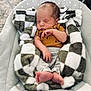 Sylas is registered to the contest to win money with this photo: newborn, baby, sleeping, blanket, checkered, onesie, infant, baby_seat, cozy, soft, peaceful, cute, small, child, resting, indoor, clothing, barefoot, portrait, relaxing