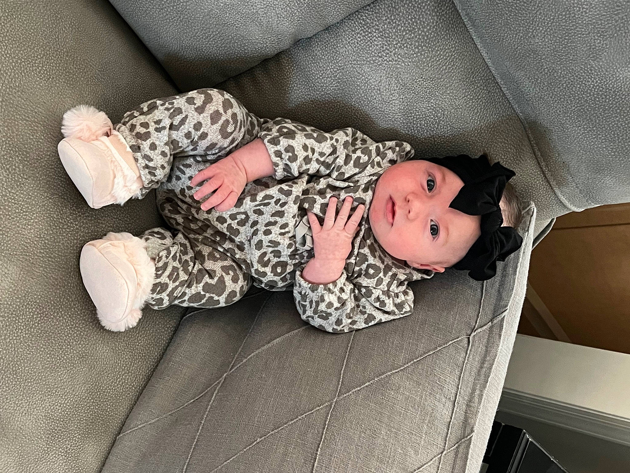 Cali is registered to the contest to win money with this photo: baby, baby_sleeping, baby_toddler_clothing, child, comfort, finger, foot, grey, head, headwear, human_leg, knee, linens, pattern, person, sitting, sleeve, sock, textile, thigh