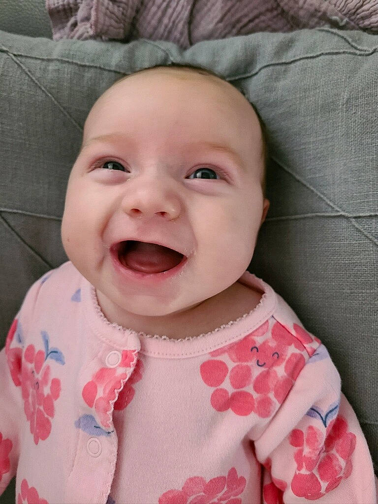 Cali is registered to the contest to win money with this photo: baby, baby_toddler_clothing, cheek, chin, dress, eye, face, facial_expression, happy, head, headwear, iris, lip, mouth, nose, person, pink, skin, sleeve, smile