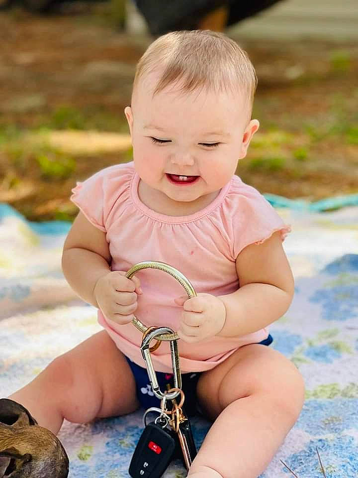 Echo is registered to the contest to win money with this photo: baby, baby_toddler_clothing, eye, face, finger, grass, hand, happy, human, joint, leg, leisure, mammal, people_in_nature, person, product, skin, smile, thigh, toddler