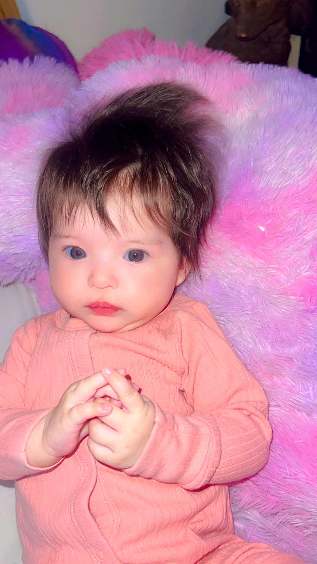 Arabella joined the competition — help win amazing prizes! baby, infant, child, face, hands, clothing, onesie, hair, pink, purple, pillow, fluffy, portrait, cute, indoors, person, skin, expression, young, resting