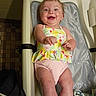 Chloe joined the competition — help win amazing prizes! arms, baby, baby_seat, child, colorful_clothing, cute, expression, face, happy, indoor, infant, joy, legs, padded_seat, person, sitting, skin, smile, swimsuit, young
