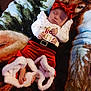 Chloe is registered to the contest to win money with this photo: baby, sleeping, red_bow, festive_outfit, blanket, wolf_pattern, infant, holiday_clothing, cute, soft_texture, cozy, indoor, child, portrait, peaceful, hands, feet, white_sleeves, red_pants, headwear