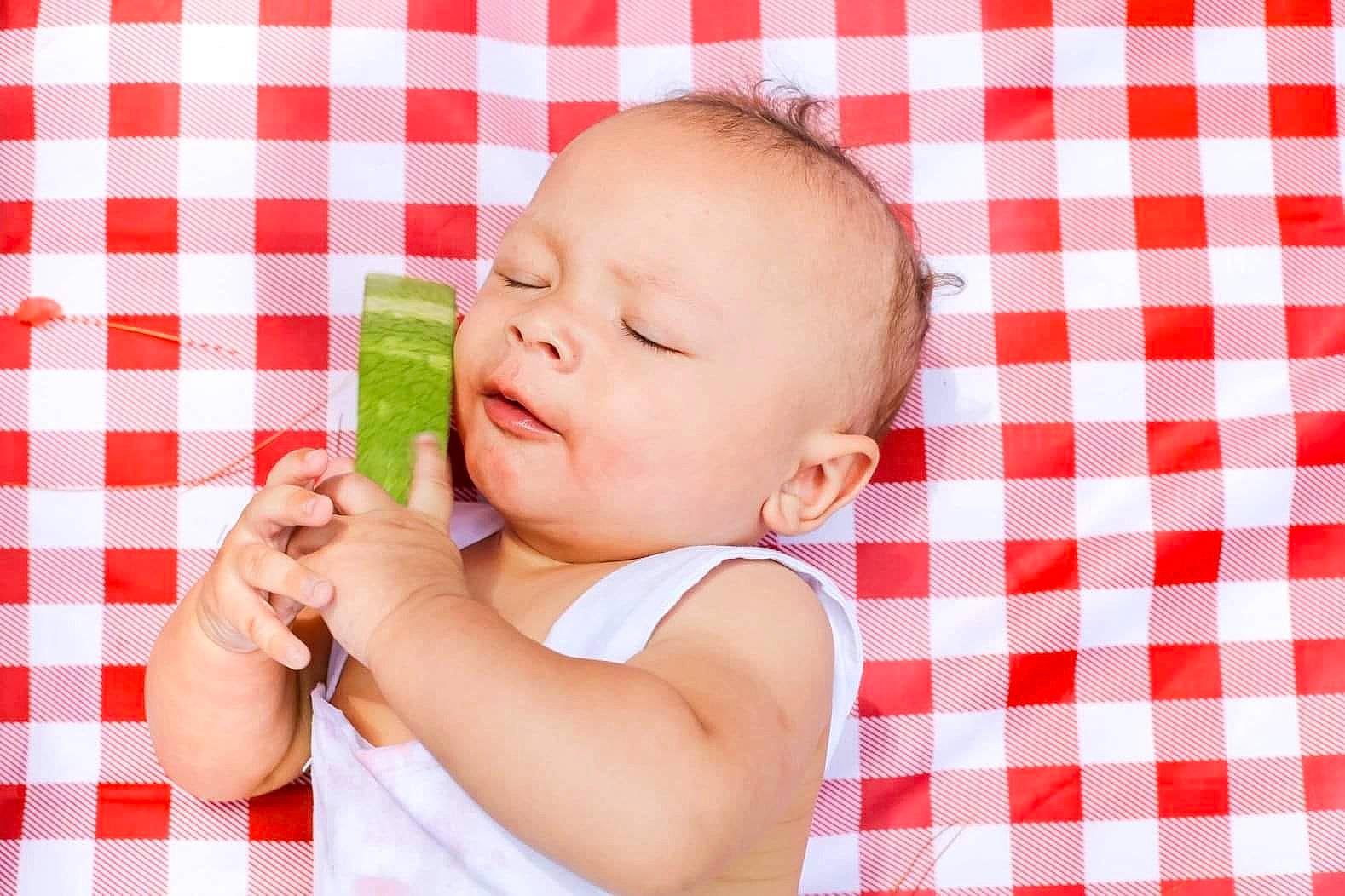 Josiah joined the competition — help win amazing prizes! baby, baby_products, baby_sleeping, baby_toddler_clothing, cheek, child, comfort, gesture, grass, happy, linens, nail, pattern, person, pink, product, sitting, skin, textile, thumb