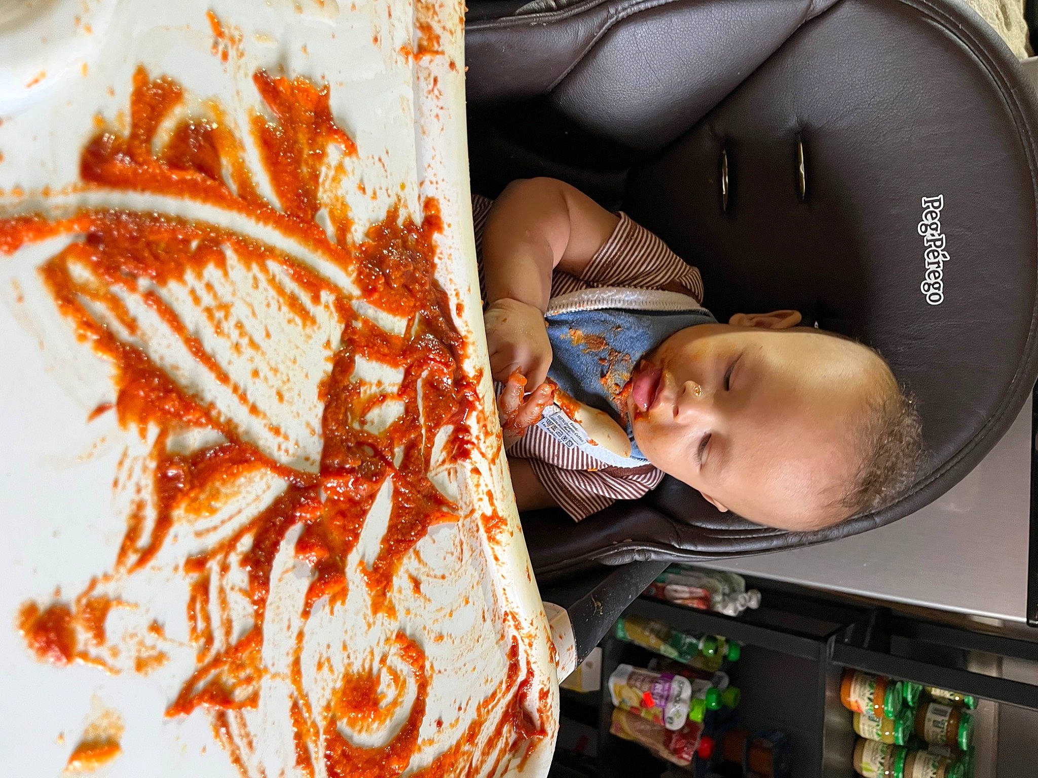 Josiah is registered to the contest to win money with this photo: audio_equipment, baby, baby_products, brown, car_seat, chair, child, comfort, cool, fashion_accessory, helmet, motif, orange, pattern, person, personal_protective_equipment, room, toddler, visual_arts