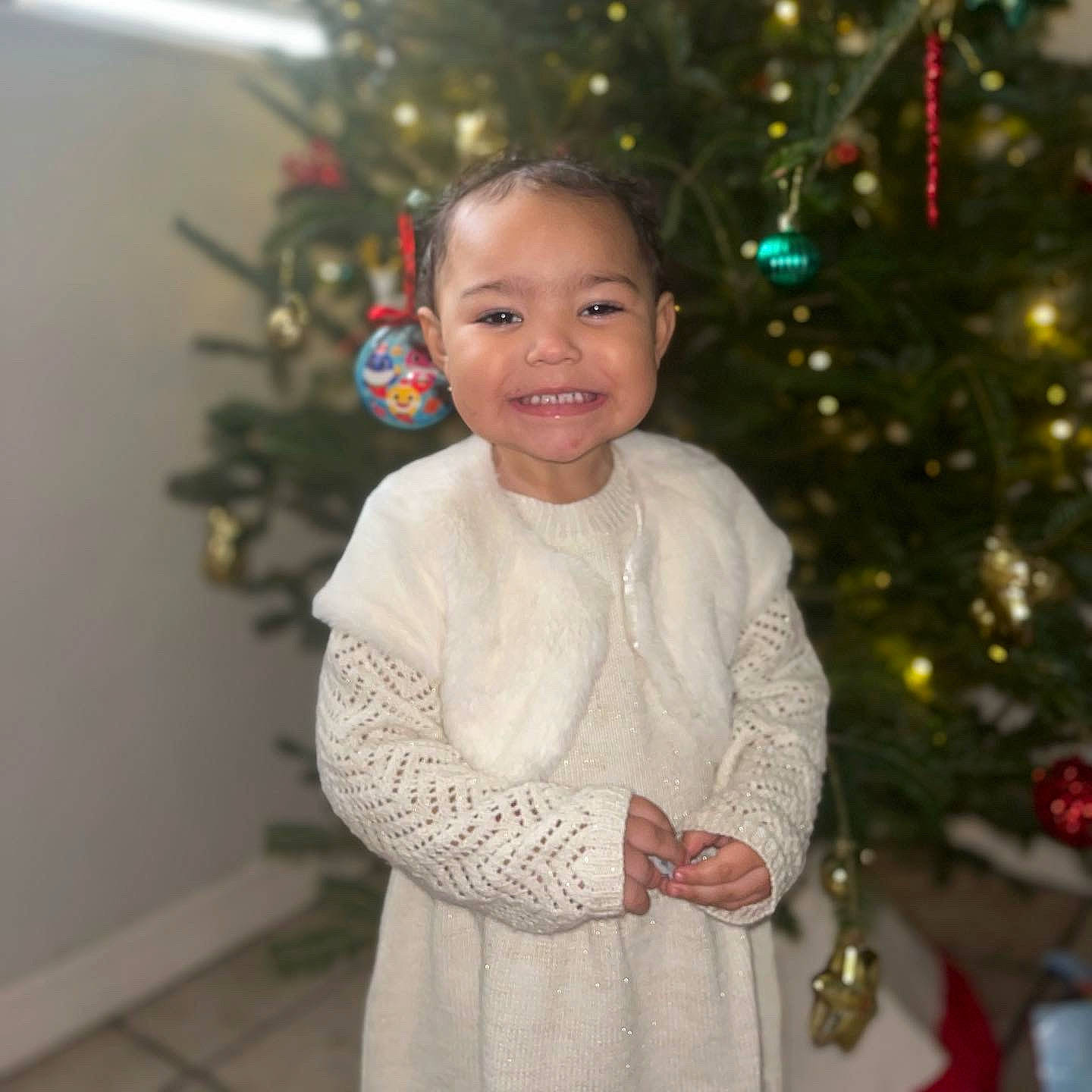 Malani joined the competition — help win amazing prizes! christmas, christmas_decoration, christmas_eve, christmas_ornament, christmas_tree, dress, event, evergreen, hair, happy, holiday, holiday_ornament, human_body, joy, ornament, person, plant, shortstraw_pine, sleeve, smile